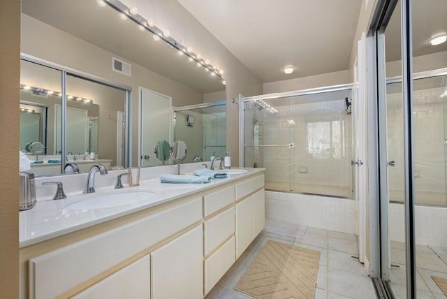 bathroom with shower with separate bathtub, vanity, and tile patterned floors