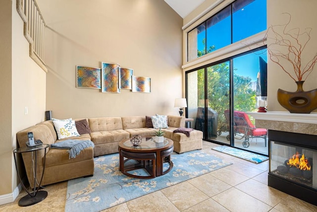 tiled living room featuring a high ceiling