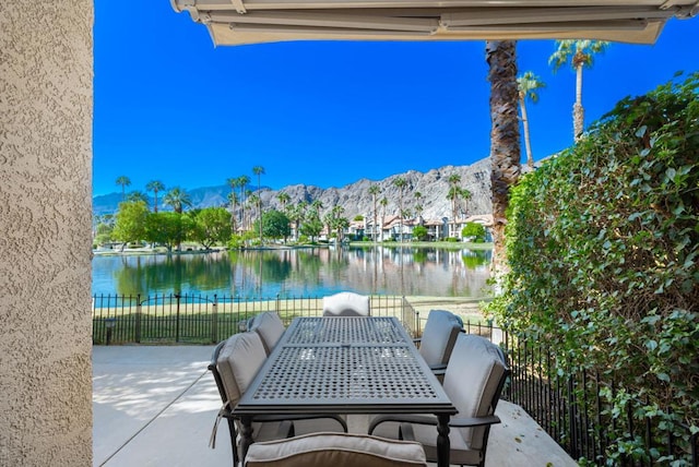 view of patio featuring a water and mountain view