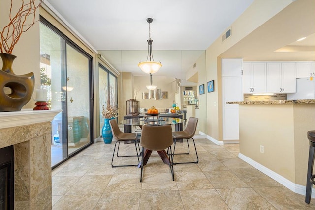 dining room featuring a high end fireplace