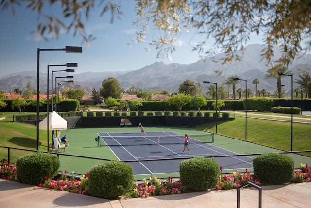 view of tennis court featuring a mountain view