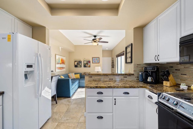 kitchen featuring white refrigerator with ice dispenser, dark stone counters, white cabinets, tasteful backsplash, and kitchen peninsula