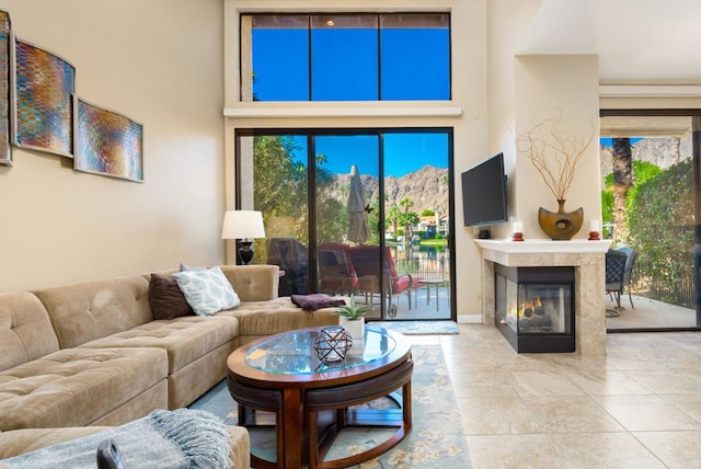 living room featuring a high ceiling and light tile patterned floors