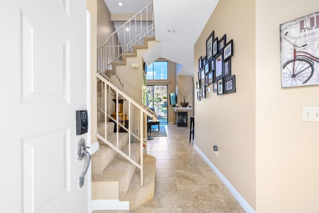 entrance foyer featuring a tiled fireplace