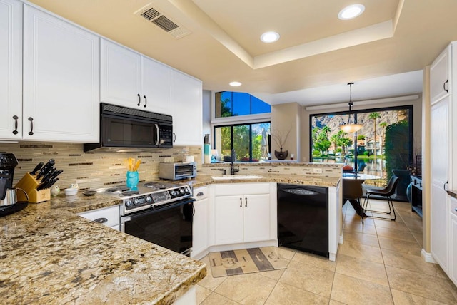 kitchen featuring white cabinetry, sink, kitchen peninsula, pendant lighting, and black appliances