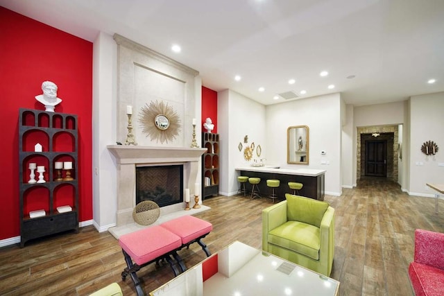 living room with a premium fireplace and hardwood / wood-style floors