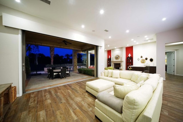 living room featuring hardwood / wood-style flooring and ceiling fan