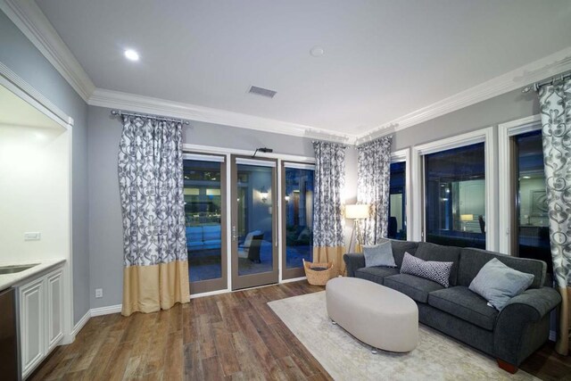 living room with crown molding and dark hardwood / wood-style floors