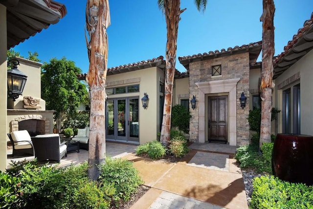 view of front of property with a patio and exterior fireplace