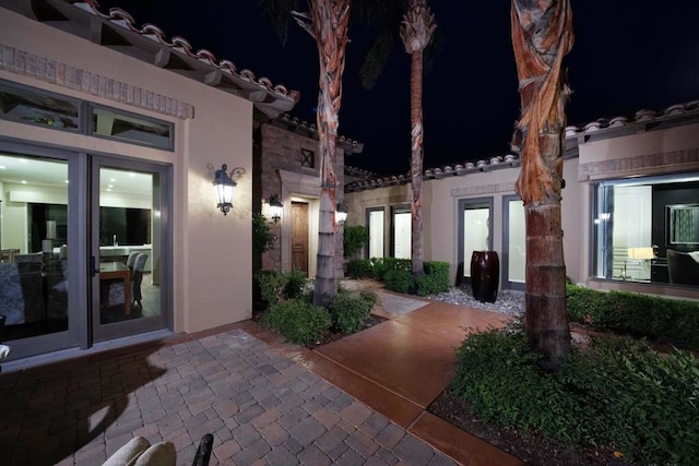 exterior entry at night featuring french doors