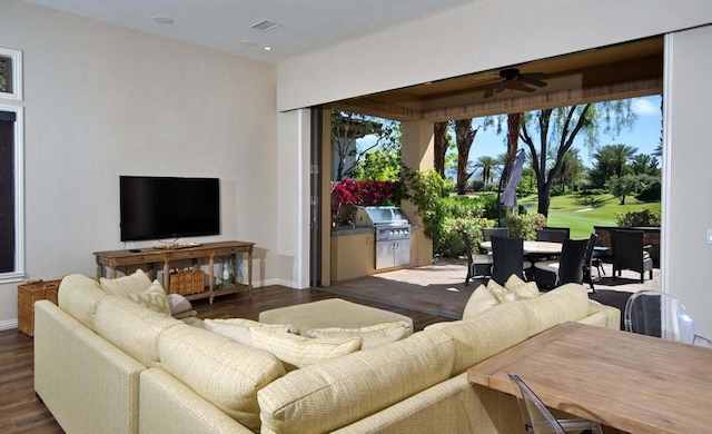 living room featuring dark hardwood / wood-style floors and ceiling fan