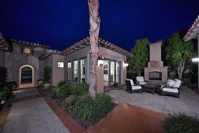 patio at night with an outdoor fireplace