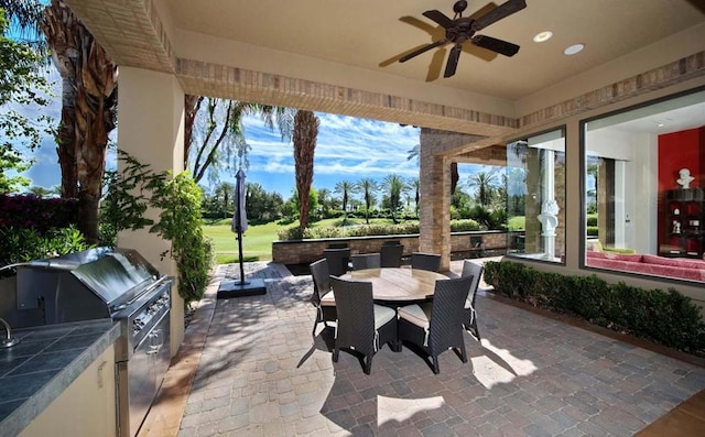 view of patio / terrace with area for grilling and ceiling fan