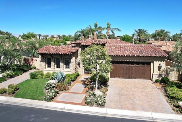 mediterranean / spanish house with a garage