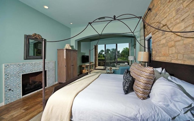 bedroom featuring wood-type flooring and vaulted ceiling