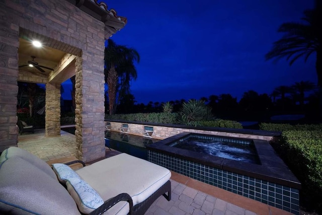 patio at twilight with an in ground hot tub