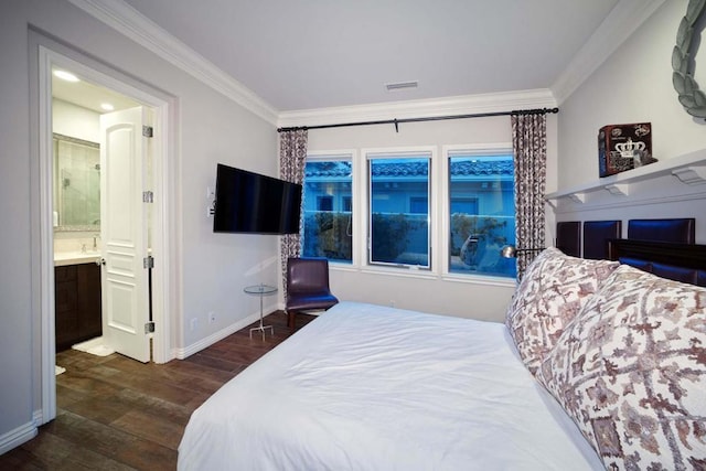 bedroom featuring dark hardwood / wood-style flooring, crown molding, and connected bathroom