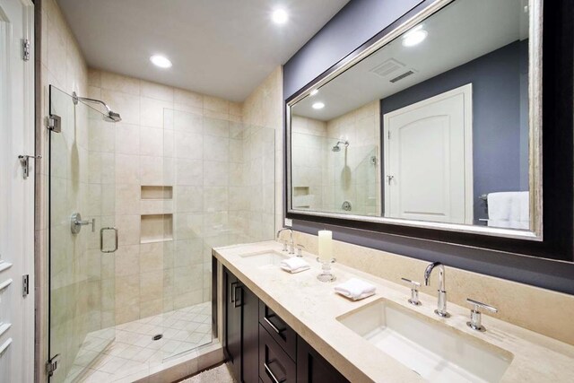 bathroom with vanity and a shower with shower door