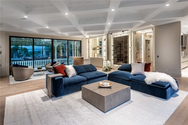 living room featuring light hardwood / wood-style floors, coffered ceiling, and beamed ceiling