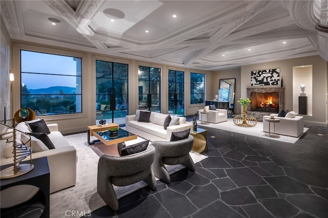 carpeted living room with coffered ceiling, a mountain view, and crown molding