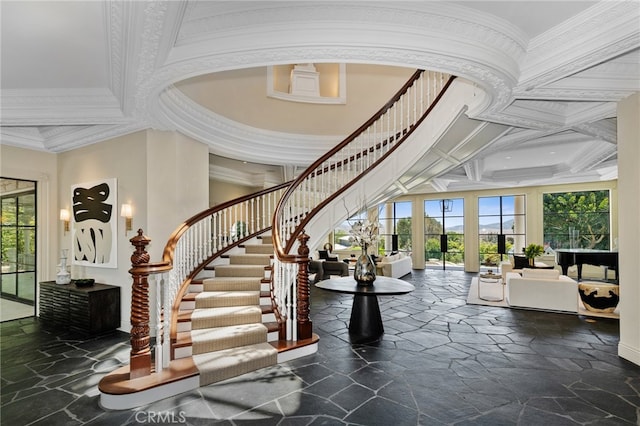 interior space with a high ceiling, plenty of natural light, and crown molding