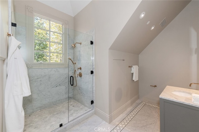 bathroom featuring vaulted ceiling, walk in shower, and vanity