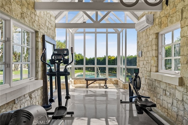 workout area featuring a healthy amount of sunlight, a wall mounted AC, and high vaulted ceiling