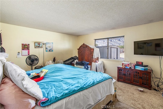 bedroom with a textured ceiling and light colored carpet