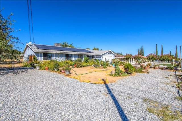 single story home featuring solar panels