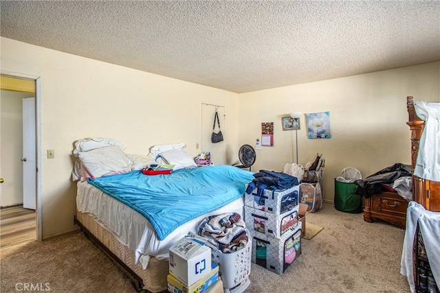 bedroom featuring a textured ceiling and carpet floors