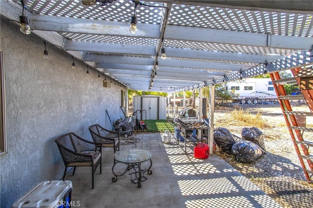 view of patio with a storage unit and a pergola