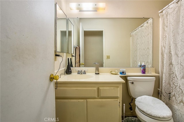 bathroom featuring vanity and toilet