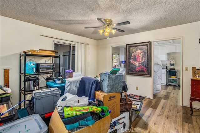 office with ceiling fan, a textured ceiling, and wood-type flooring