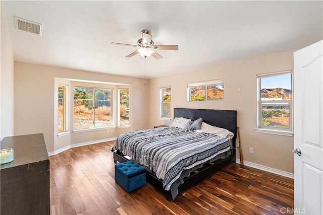 bedroom with ceiling fan and dark hardwood / wood-style floors