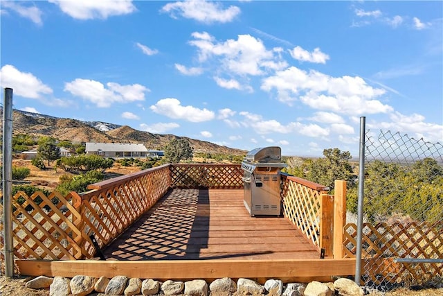 wooden deck featuring a grill and a mountain view