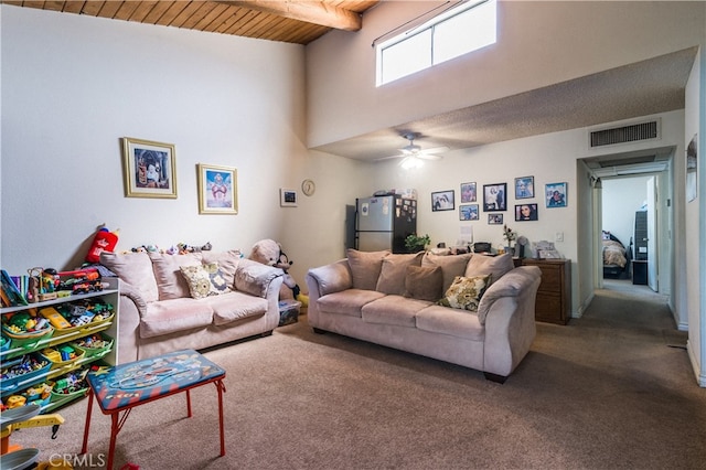 living room featuring beamed ceiling, high vaulted ceiling, carpet, ceiling fan, and wooden ceiling