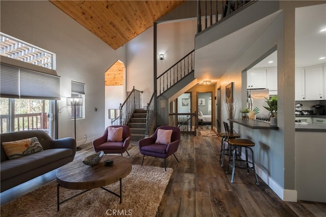 living room featuring wooden ceiling, dark wood-type flooring, and high vaulted ceiling