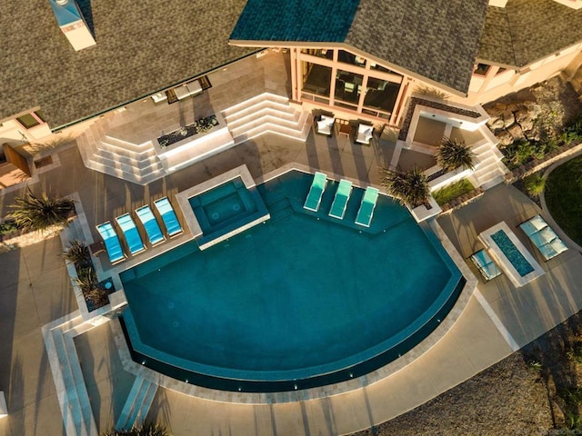 view of swimming pool with an in ground hot tub