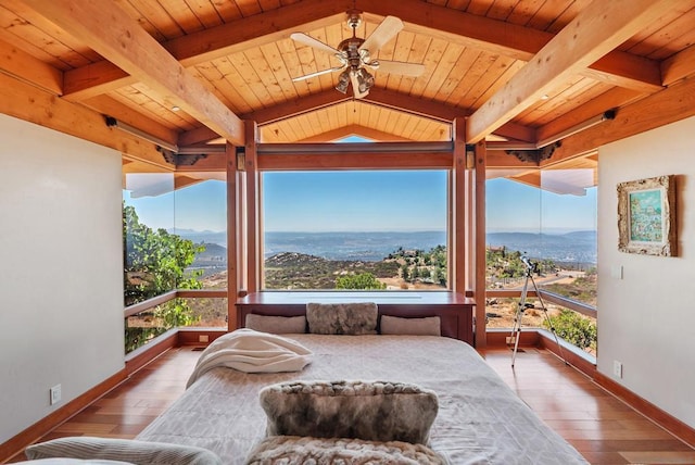 sunroom featuring a wealth of natural light, wooden ceiling, and ceiling fan