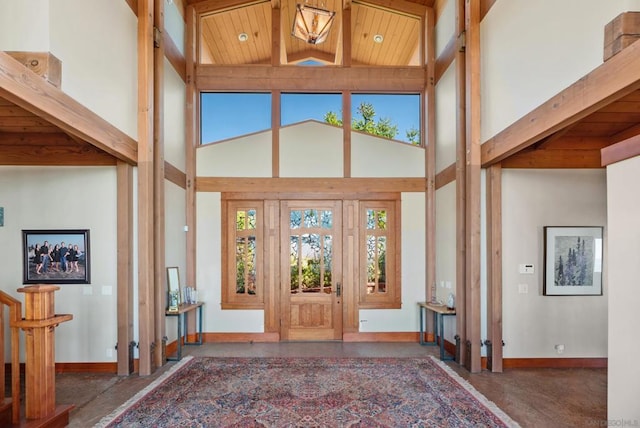 entrance foyer featuring high vaulted ceiling, a healthy amount of sunlight, and wood ceiling