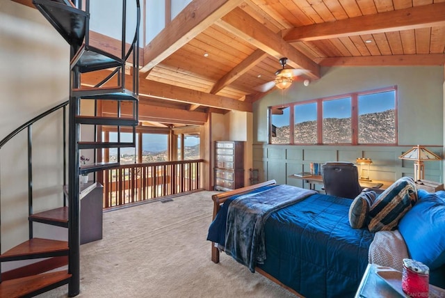 carpeted bedroom with a mountain view, vaulted ceiling with beams, ceiling fan, and wooden ceiling