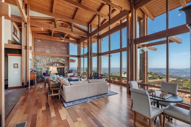 living room featuring a healthy amount of sunlight, wooden ceiling, and beam ceiling