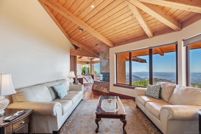 living room with a water and mountain view, wood-type flooring, a fireplace, beamed ceiling, and wood ceiling