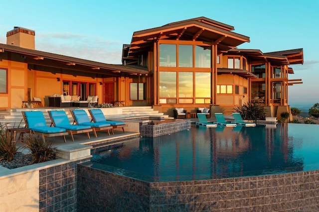 view of swimming pool featuring outdoor lounge area and an in ground hot tub