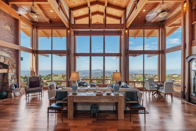 living room with high vaulted ceiling, ceiling fan, wood ceiling, and a wealth of natural light