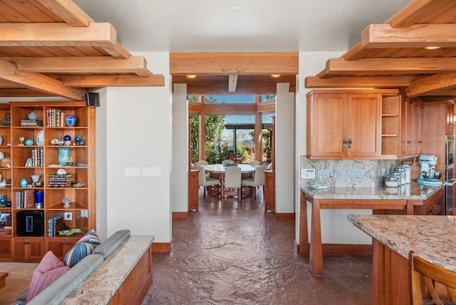 interior space with beam ceiling, light stone countertops, backsplash, and wood ceiling