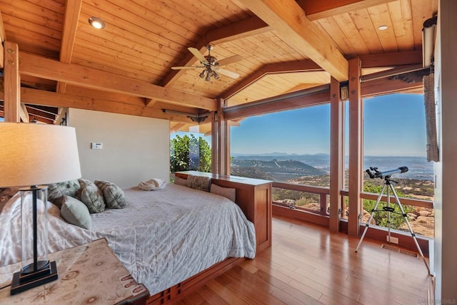 bedroom with wood ceiling, multiple windows, ceiling fan, and wood-type flooring