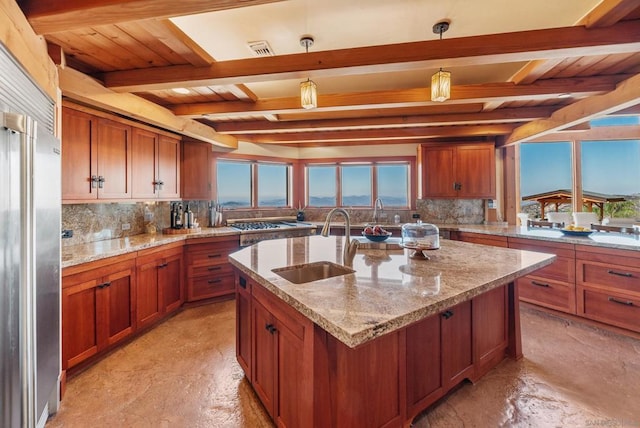 kitchen with beamed ceiling, sink, and hanging light fixtures