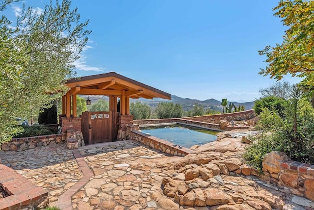 view of swimming pool featuring a mountain view and a jacuzzi