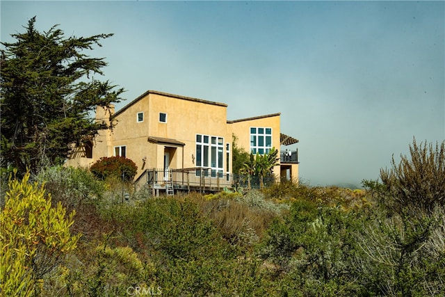 back of house with a wooden deck